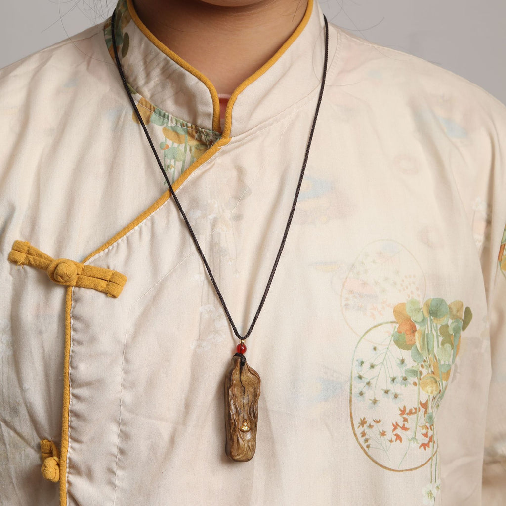 Minimalist handcrafted wooden pendant in a wabi-sabi style
