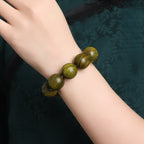 Xigura Patina handcrafted sandalwood bookmark, wood texture close-up for a warm, quiet home.