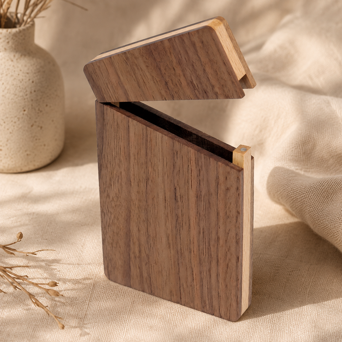 Open black walnut business card holder displaying business cards inside, featuring a clean interior and natural wood texture.