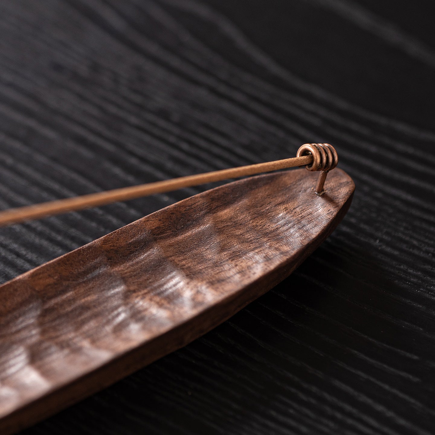 Close-up of a handcrafted black walnut incense holder highlighting its natural wood grain and smooth hand-sanded finish.