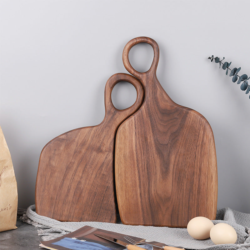 Pair of handcrafted black walnut serving boards styled with bread and coffee on a wooden table for everyday dining.