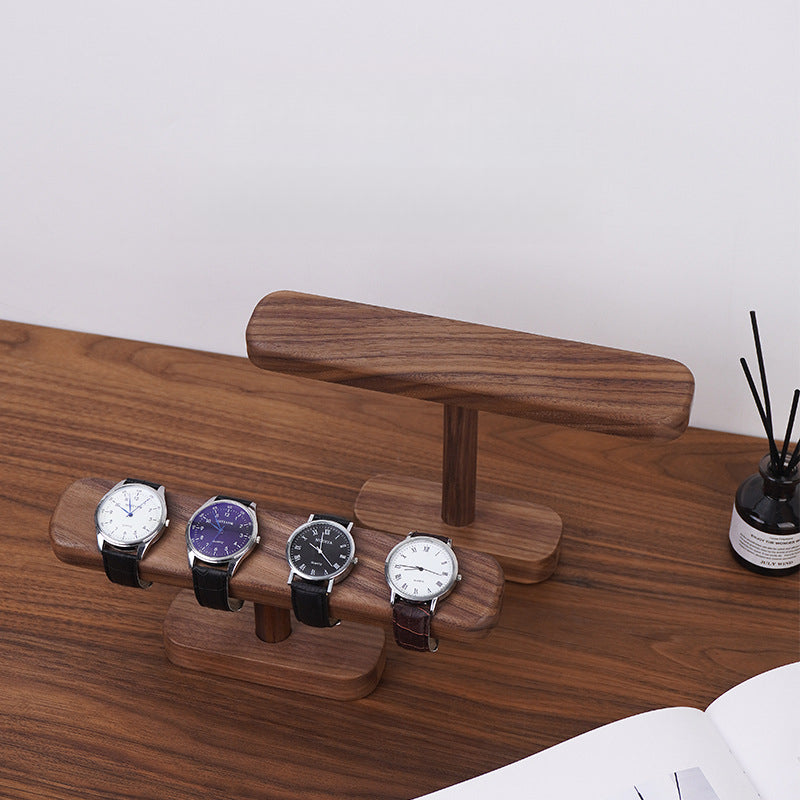 Solid black walnut watch stand holding a single wristwatch for everyday storage and display.