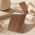 Handcrafted black walnut wood business card holder with a slim rectangular design and natural wood grain.