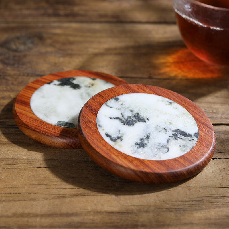 Close-up detail of handcrafted wood and marble coaster surface