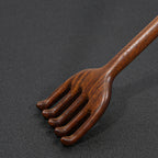 Close-up detail of handcrafted wooden back scratcher smooth finish