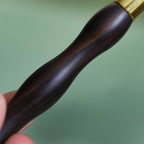 Close-up of handcrafted wood facial roller for skin massage
