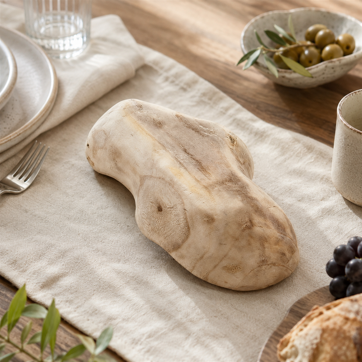 Handcrafted paulownia wood fruit tray styled with fresh fruit, showcasing its natural curves and warm wood texture.