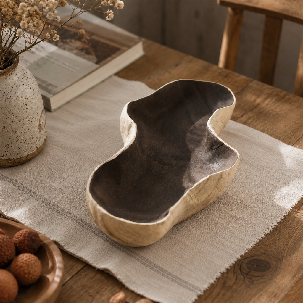 Handcrafted paulownia wood fruit tray displayed on a wooden table in a warm, natural home setting with a calm rustic aesthetic.