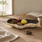 Handcrafted paulownia wood fruit tray with a natural organic shape, rustic finish, and sculptural solid wood design.