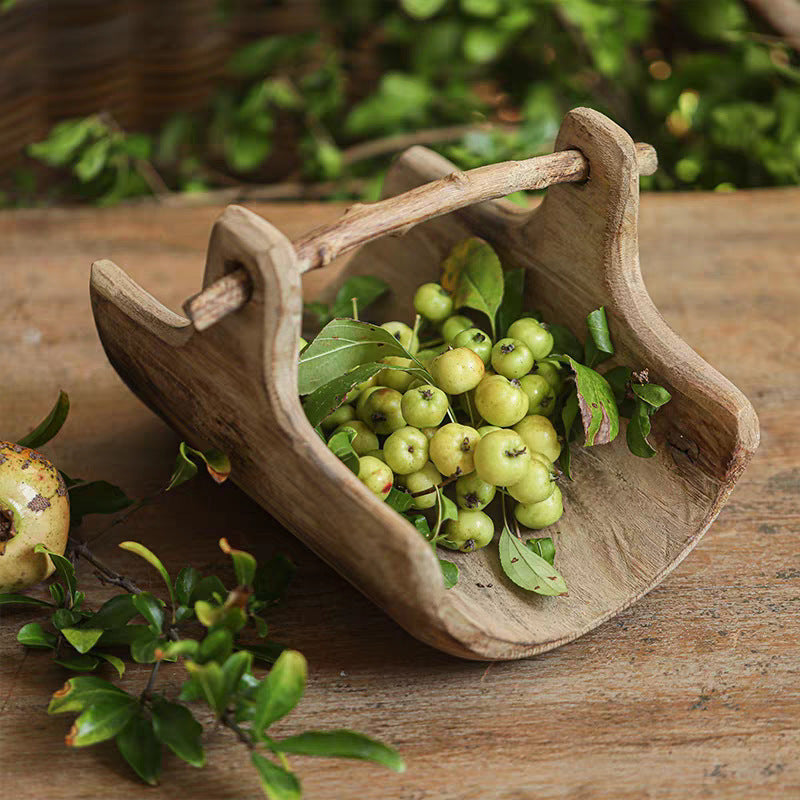 Handcrafted willow fruit basket showing the curved wooden structure and natural grain details in a warm home setting.