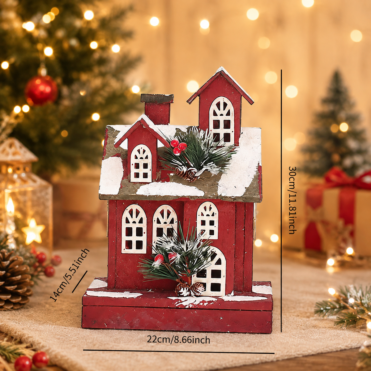 Handcrafted wooden Christmas house displayed on a tabletop beside a Christmas tree, adding warmth and festive charm to holiday décor.