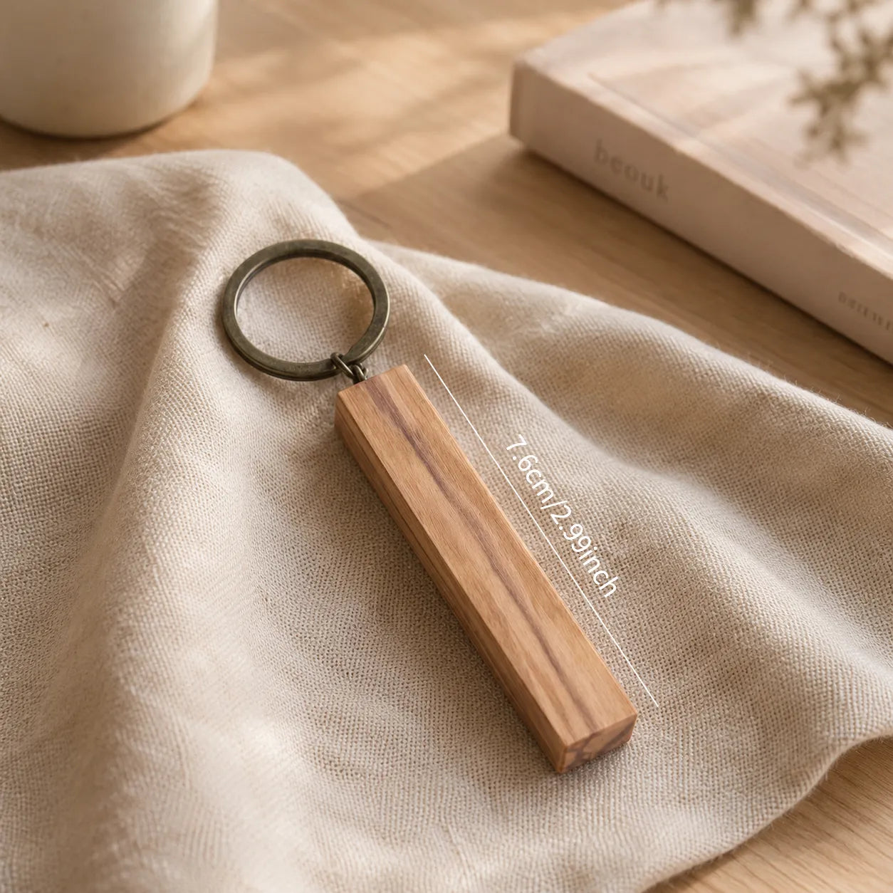 Detailed view of handcrafted olive wood keychain highlighting smooth edges, natural material, and artisan workmanship.