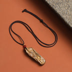 Handmade solid wood pendant necklace with natural wood grain