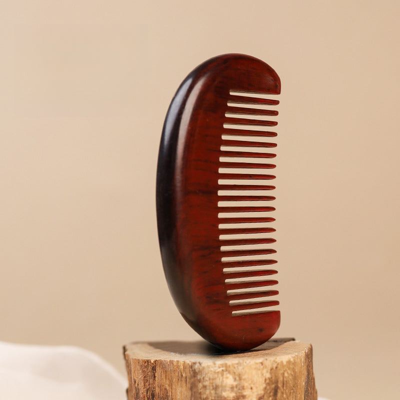 Minimalist wooden beard comb with natural grain texture detail