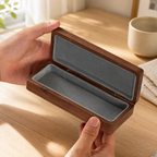 Close-up view of black walnut wood grain and handmade details on a personalized eyewear case.