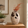 Natural root wood vase styled with decorative branches, highlighting its organic form, hollow details, and distinctive wood grain.