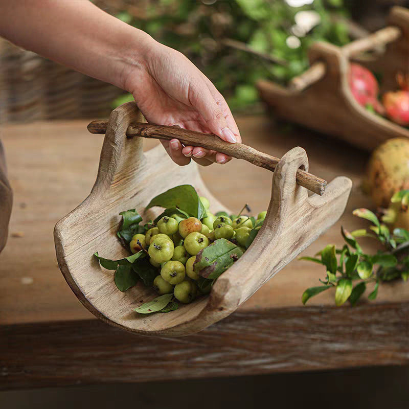 Handcrafted willow serving basket styled on a dining surface with natural elements for a warm and simple home atmosphere.