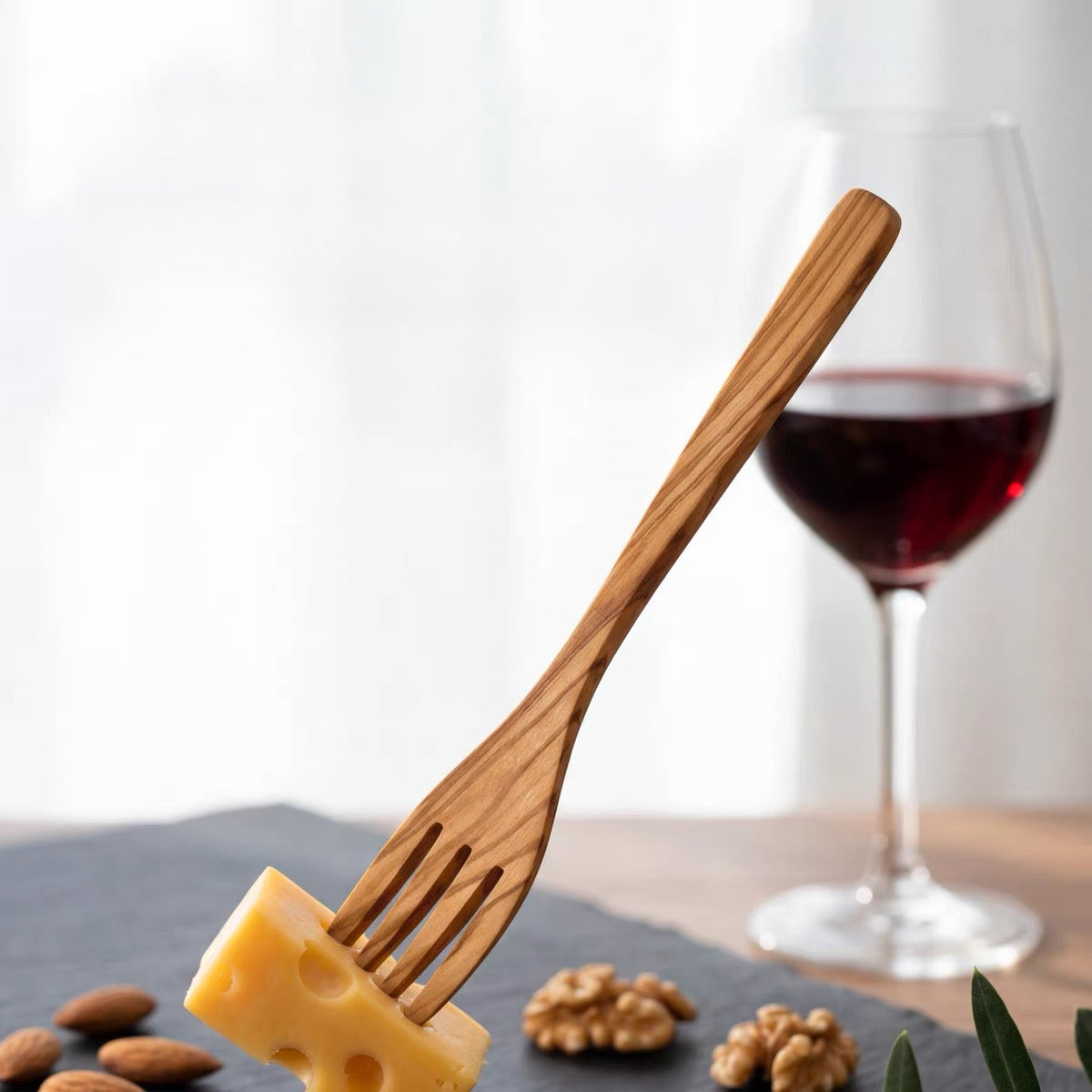 Close-up of natural olive wood grain on handcrafted fruit fork handle