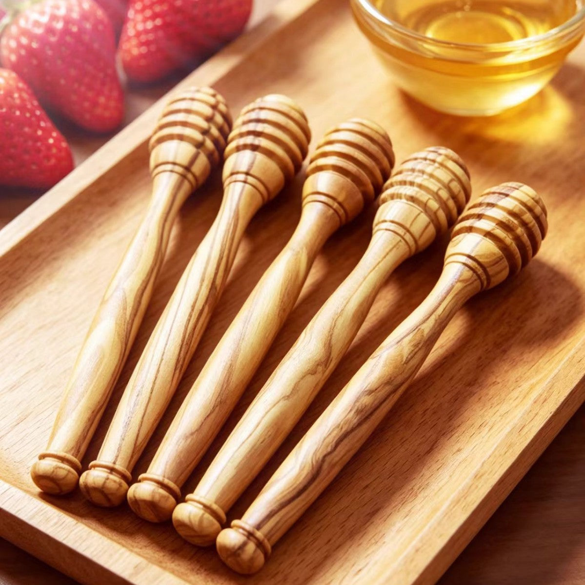 Olive wood honey dipper stick on a breakfast table with bread, fruit, and honey.