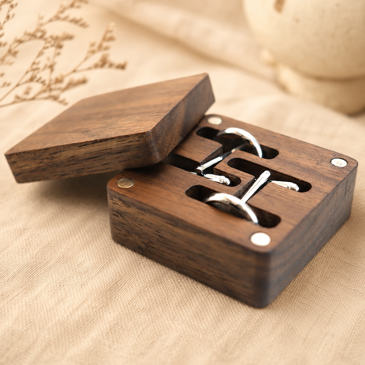 Black walnut cufflink storage box displayed on a wooden tabletop, offering elegant organization for dress accessories.