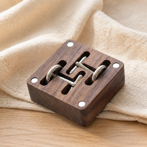 Open black walnut cufflink storage box showing precision-cut compartments for storing multiple pairs of cufflinks.
