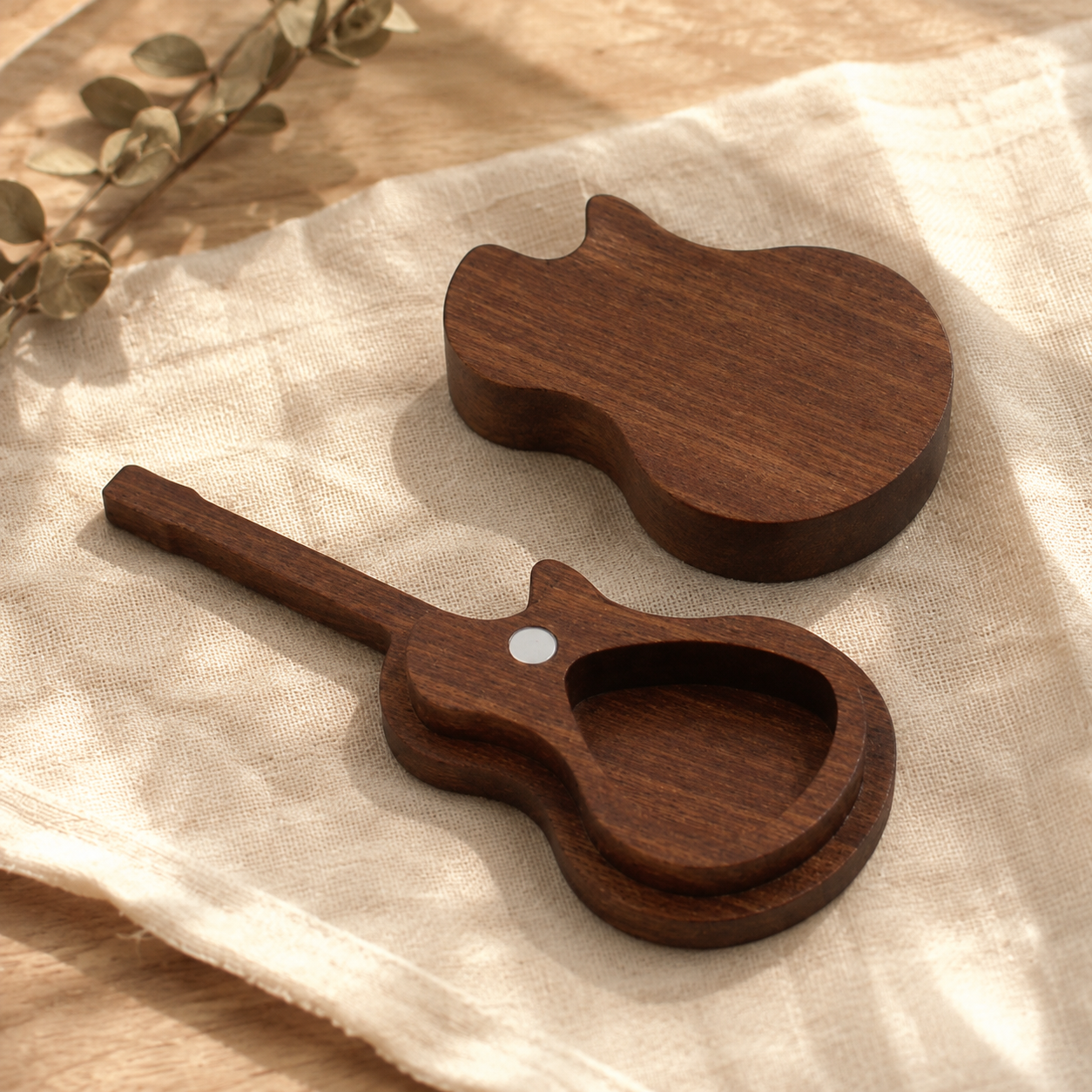 Personalized black walnut guitar pick case with magnetic guitar-shaped lid, handcrafted for storing and protecting guitar picks.