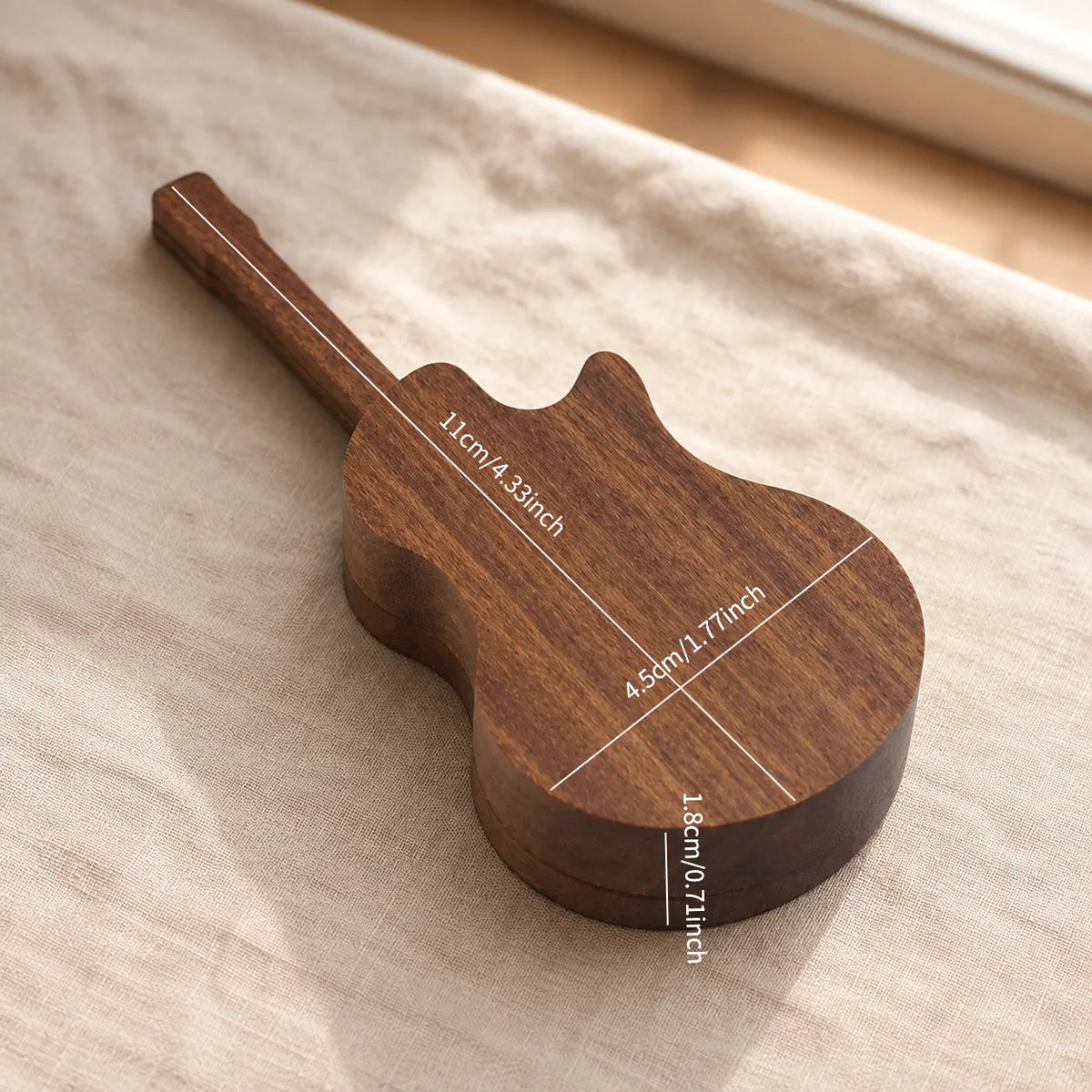 Personalized black walnut guitar pick case presented as a unique gift for guitarists, combining practical storage with elegant wooden craftsmanship.