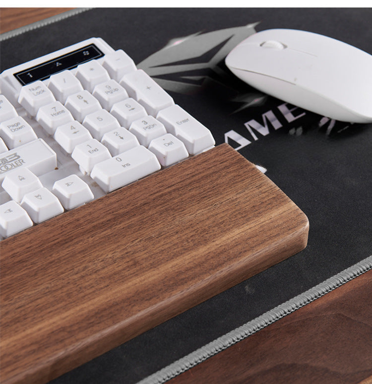 Side view of solid black walnut keyboard wrist rest with ergonomic height for mechanical keyboards.