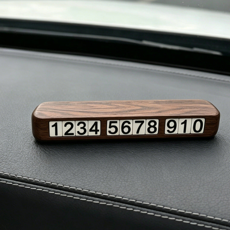 Handcrafted personalized black walnut parking number plate with magnetic number tiles for car dashboard.