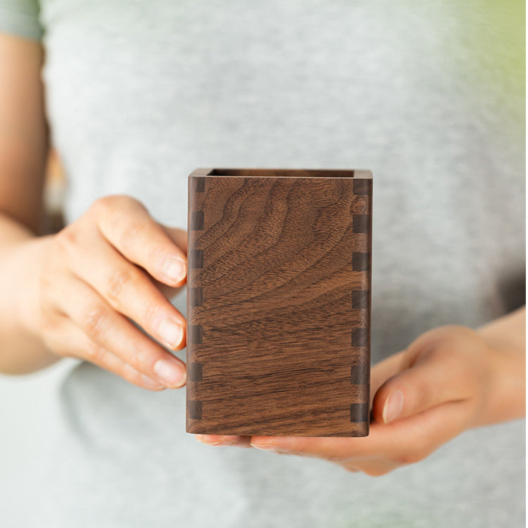 Close-up of handcrafted black walnut pen holder featuring smooth finish and rich natural wood grain.