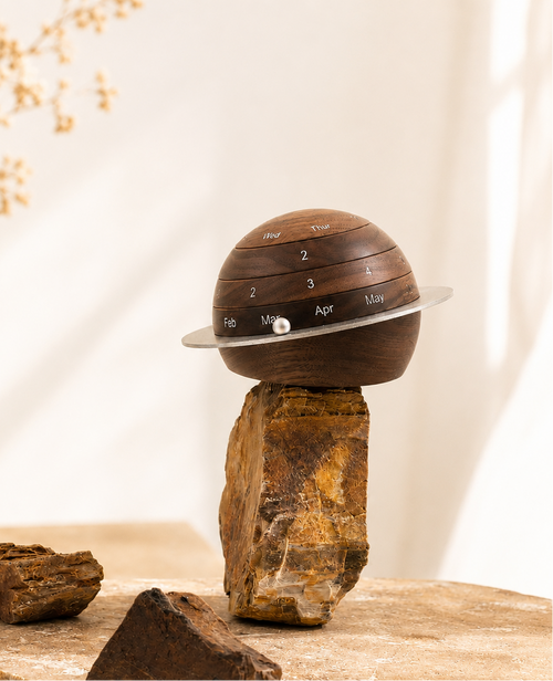 Personalized black walnut perpetual calendar with rotating wooden rings for displaying the day, date, and month in a timeless minimalist design.