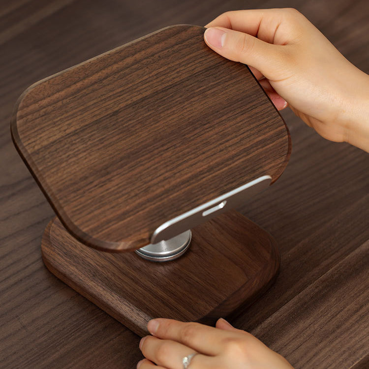 Close-up of handcrafted black walnut phone and tablet stand featuring smooth edges and natural wood grain.