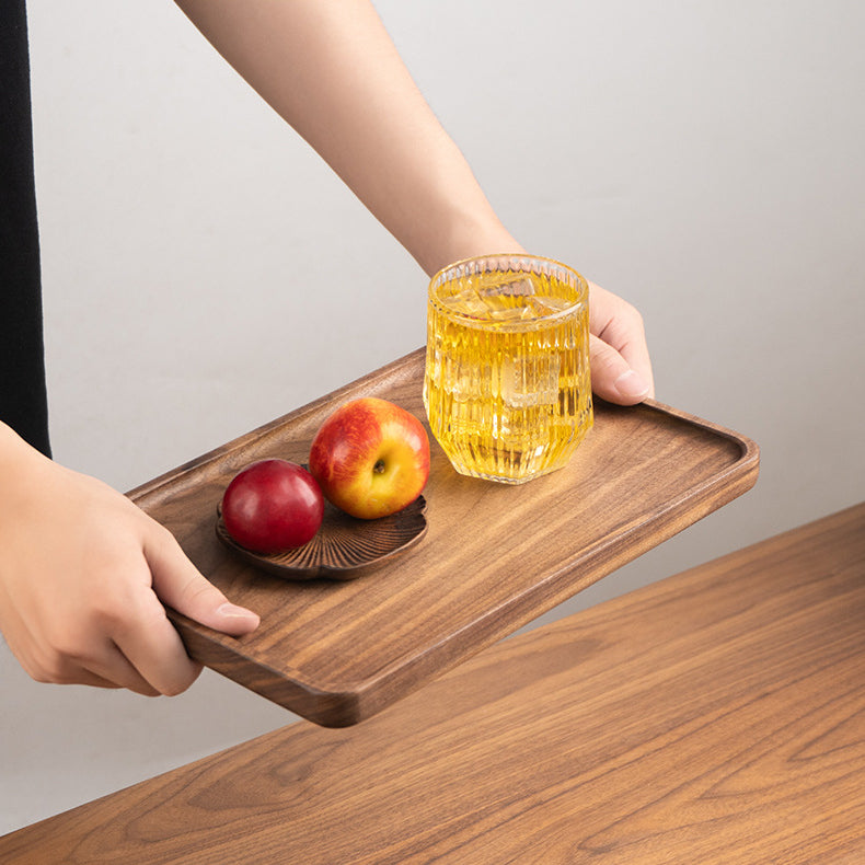 Solid black walnut serving tray styled as elegant home decor on a dining table or kitchen countertop.