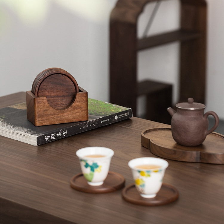 Solid black walnut wood coaster set neatly stored in a handcrafted matching wooden holder.