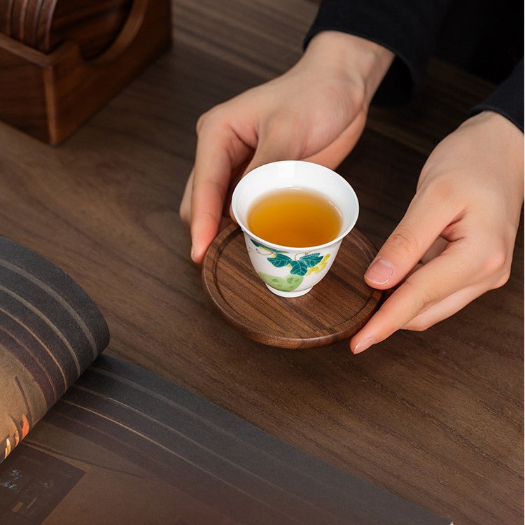 Close-up of handcrafted black walnut wood coasters showing natural wood grain and smooth hand-sanded finish.