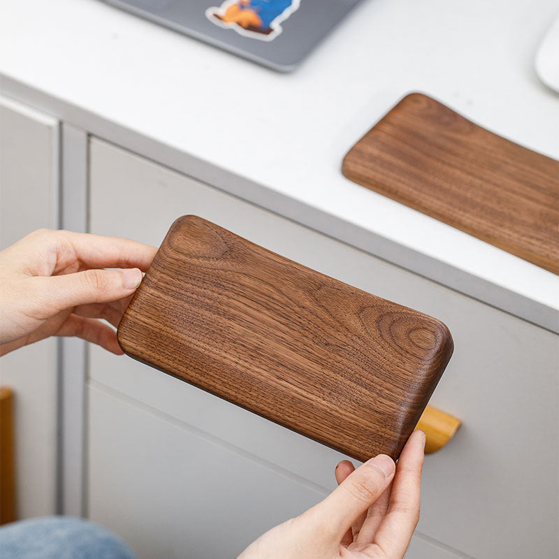Personalized black walnut wood mouse wrist rest with custom laser engraving for a unique desk accessory.