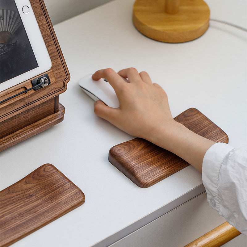 Ergonomic black walnut wood mouse wrist rest designed to provide natural wrist support during work and gaming.