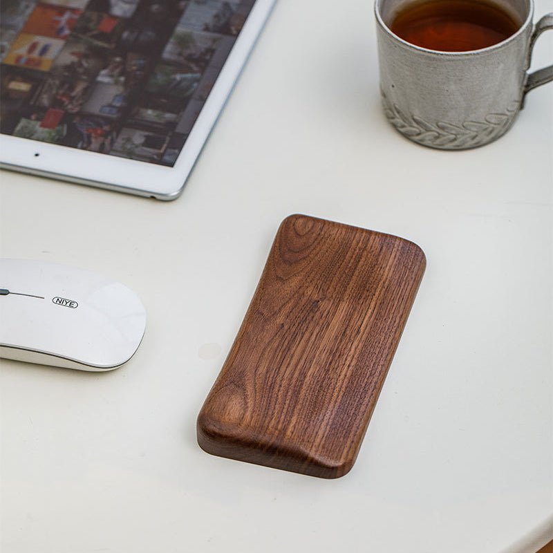 Handcrafted personalized black walnut wood mouse wrist rest with ergonomic support for comfortable everyday computer use.