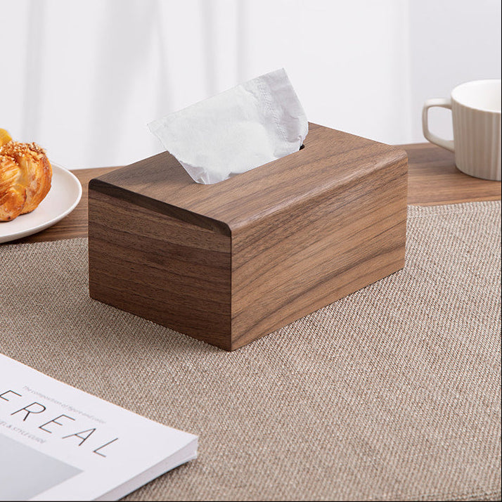 Handcrafted personalized black walnut wood tissue box cover on a table with tissues for everyday home use.