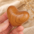 Personalized cherry wood pocket heart with a smooth handcrafted finish and unique natural wood grain, designed as a comforting keepsake.