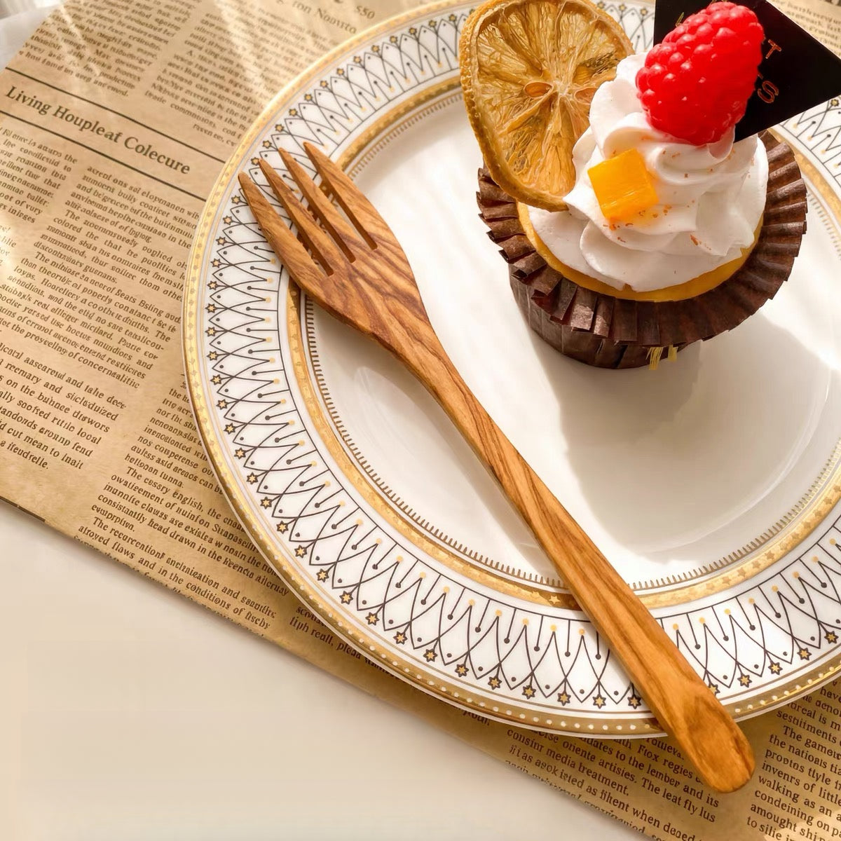 Personalized olive wood fruit fork with smooth hand-finished handle on wooden surface