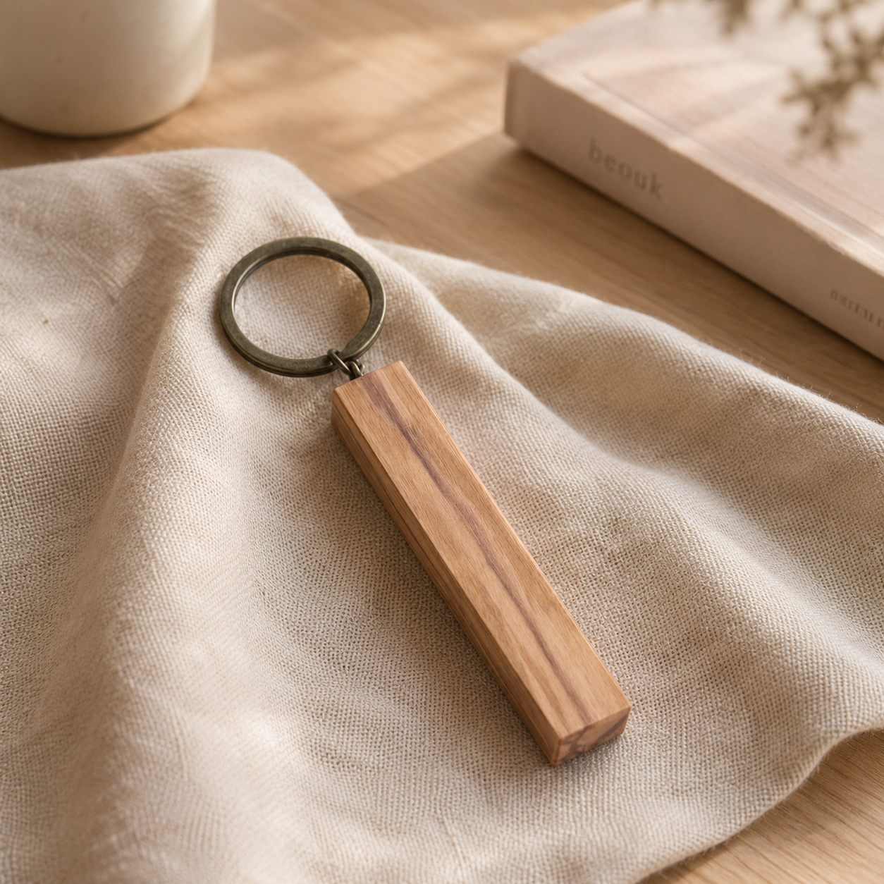 Personalized olive wood keychain with custom engraving, showing natural wood grain and handmade craftsmanship.