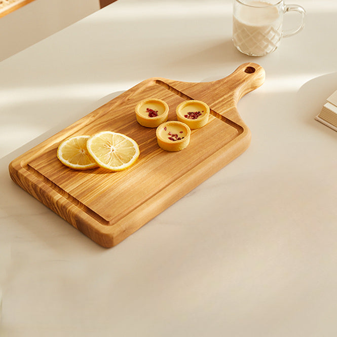 Handcrafted olive wood steak serving board with juice groove for serving steaks, cheese, bread, and charcuterie.