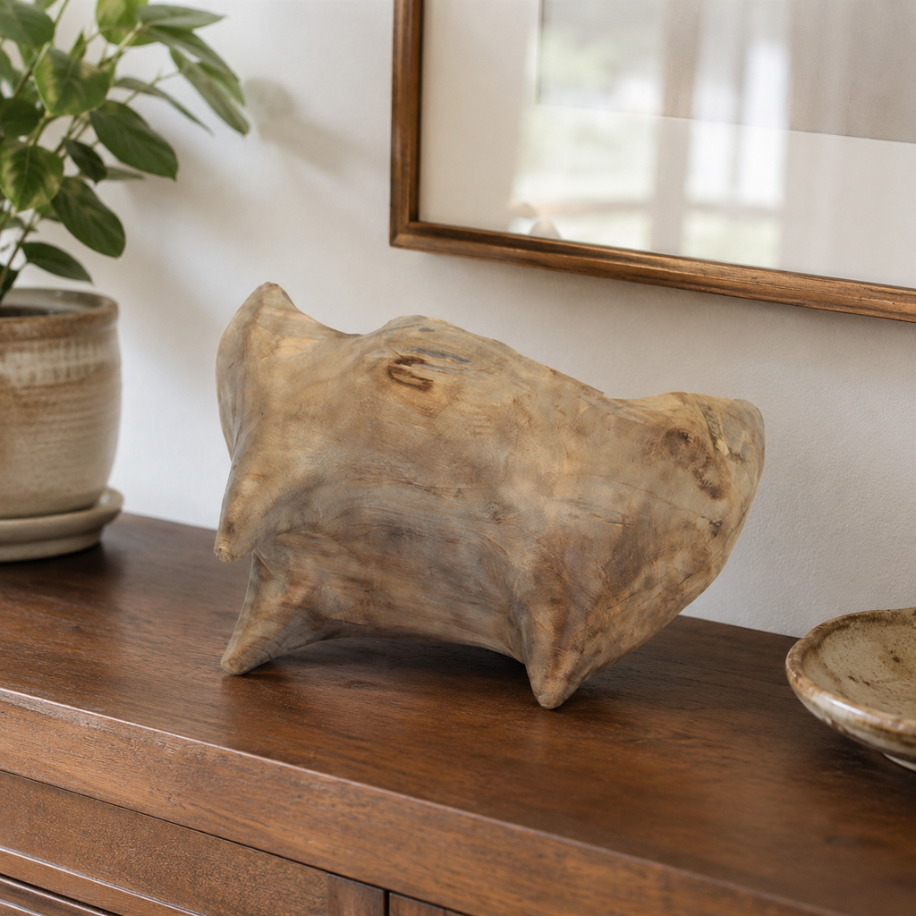 Close-up of a handcrafted wooden fruit bowl showing its natural wood texture, irregular edges, and individually carved character.