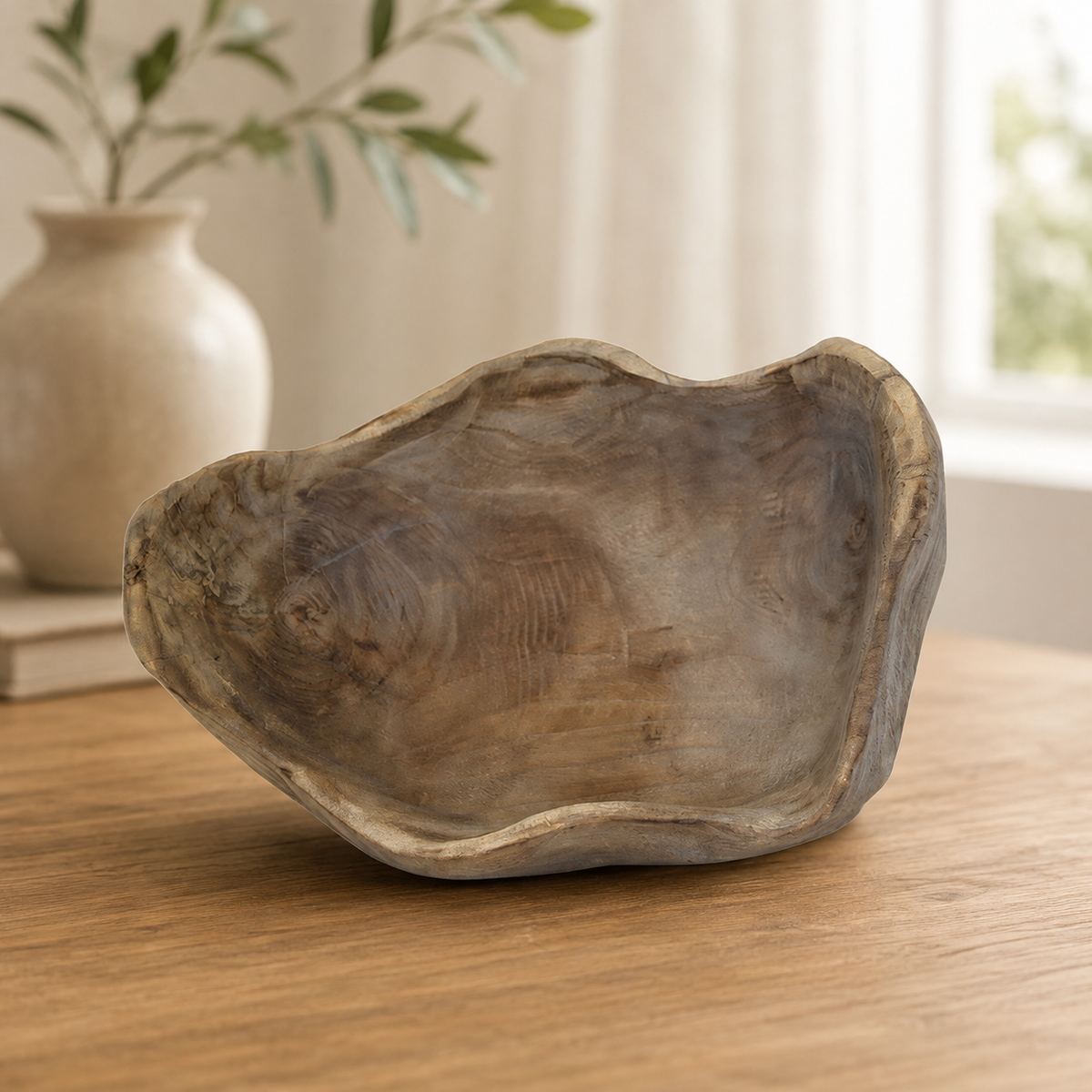 Side view of the rustic wooden fruit bowl highlighting its sculptural raised base, organic silhouette, and handcrafted finish.
