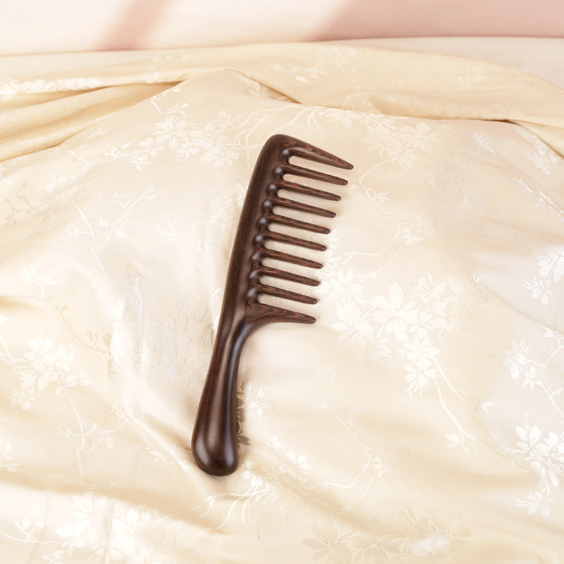 Solid wood hair comb placed in soft natural light lifestyle scene