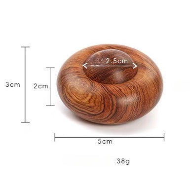 Wabi-sabi style solid wood finger spinner in soft natural light