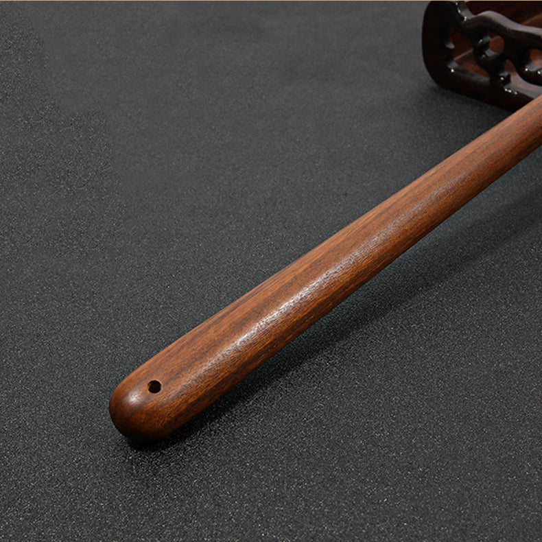 Wabi-sabi style wooden back scratcher in warm natural lighting