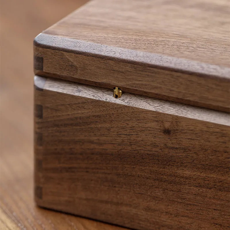 Handmade wooden memory box used to organize jewelry, photographs, letters, and personal keepsakes at home.