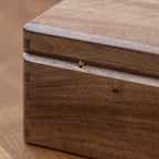 Handmade wooden memory box used to organize jewelry, photographs, letters, and personal keepsakes at home.